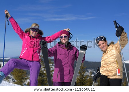 happy friends group of woman girls have fun at winter season at beautiful sunny  snow day with blue sky in background