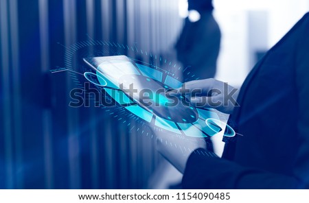 Female IT engineer working on a tablet computer in server room at modern data center