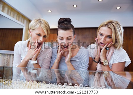 happy girls group  have fun while shopping in jewelry store