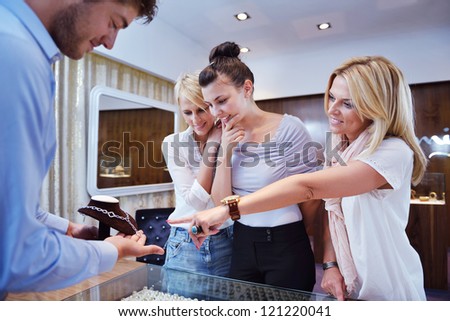 happy girls group  have fun while shopping in jewelry store