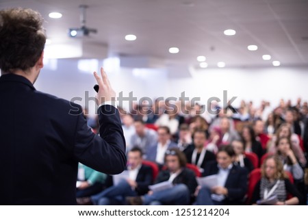 young businessman at business conference room with public giving presentations. Audience at the conference hall. Entrepreneurship club