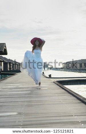 asian  bride with a veil on the beach in the sky and blue sea. honeymoon on the fantastic island at summer