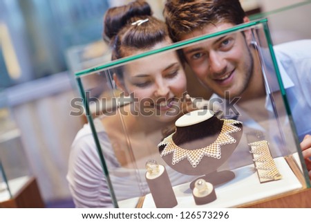 happy young romantic couple in love buy jewelry ring in luxury store