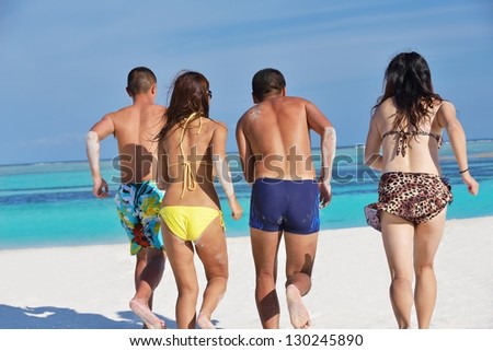 group of happy young people have fun and joy at the  white sand  beach on beautiful summer  day