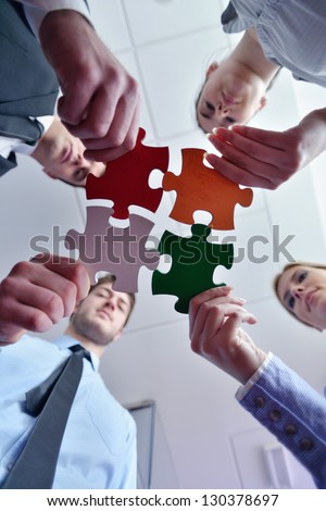 Group Of Business People Assembling Jigsaw Puzzle And Represent Team Support And Help Concept