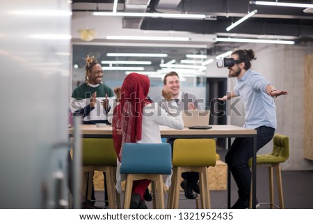 Multiethnic Business team using virtual reality headset in office meeting  Developers meeting with virtual reality simulator around table in creative office.