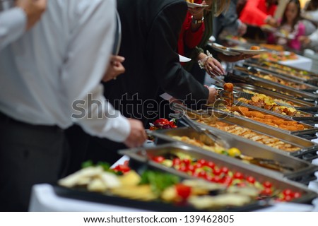 People Group Catering Buffet Food Indoor In Luxury Restaurant With Meat Colorful Fruits And Vegetables