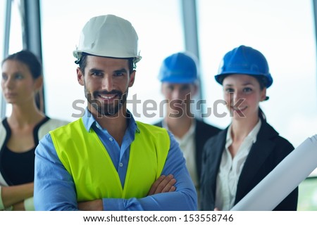 business people group on meeting and presentation  in bright modern office with construction engineer architect and worker looking building model and blueprint planbleprint plans