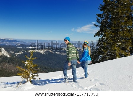 Young Couple In winter Snow Scene at  beautiful sunny day