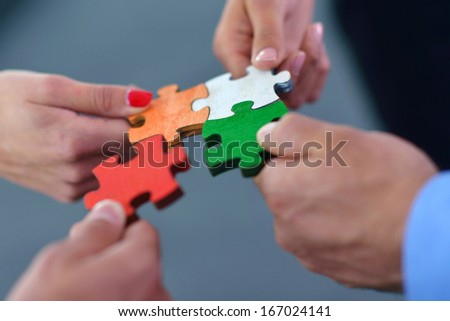 Group Of Business People Assembling Jigsaw Puzzle And Represent Team Support And Help Concept