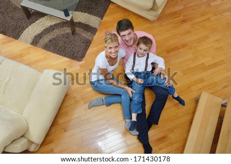 Happy Young Family With Kids In Bright Modern Living Room Have Fun And Looking Big Flat Lcd Tv