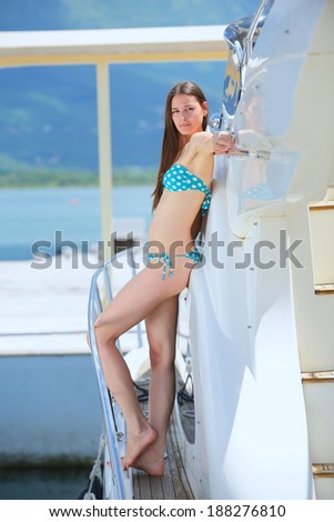 woman lies on a luxury yacht in the sea and looking to the horizon