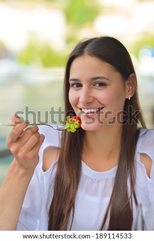 young woman have fresh healthy salad meal lunch at restaurant