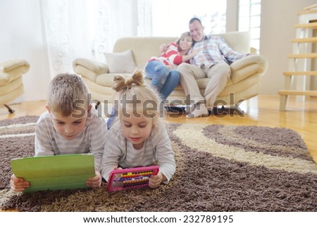 happy young family have fun  with their children at modern living room home indoors