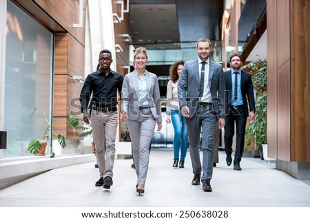 young multi ethnic business people group walking