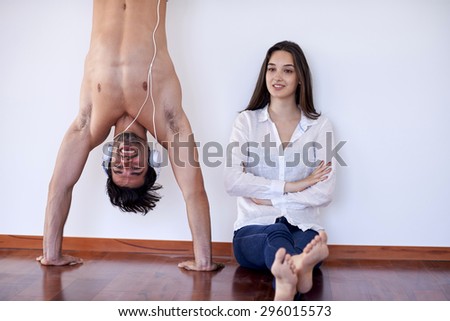 happy young romantic couple have fun relax smile at modern home livingroom indoors happy young romantic couple have fun relax smile at modern home livingroom indoors