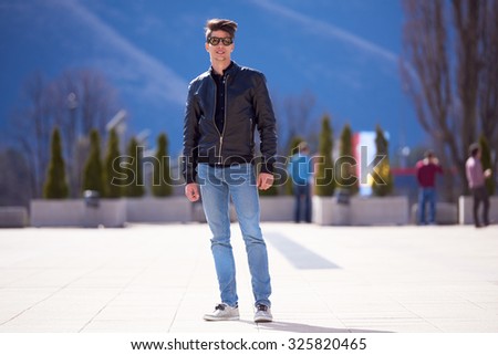 young handsome  man with modern fashion leather jacket and style sunglasses