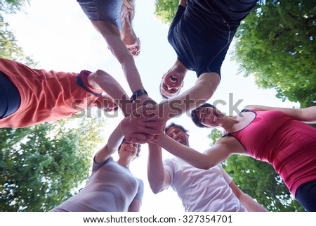jogging people group, friends have fun,  hug and stack hands together after training