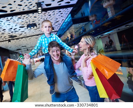 happy  young family with shopping bags in mall
