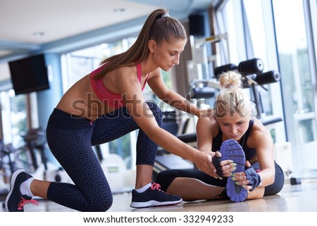 woman exercise and  working out with fitness personal trainer in gym