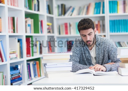 student reading book in library Study lessons for  exam.