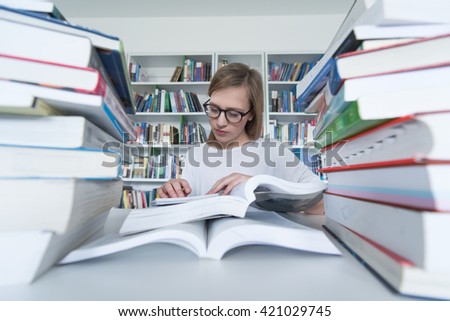 female student study in  library using laptop and searching for informations on internet