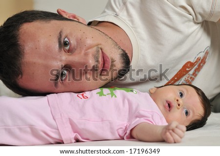 indoor portrait with happy young family with cute little baby