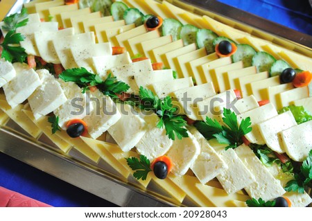 tasty cheese slices  and tasty food at buffet party food arrangement on table closeup