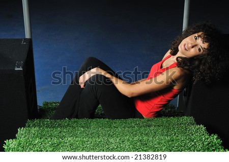 young woman relax on green stairs with speakers around