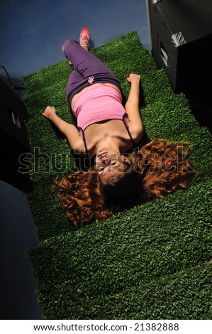 young woman relax on green stairs with speakers around