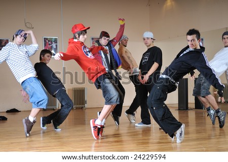 group of young happy boys dance  together in dence studio