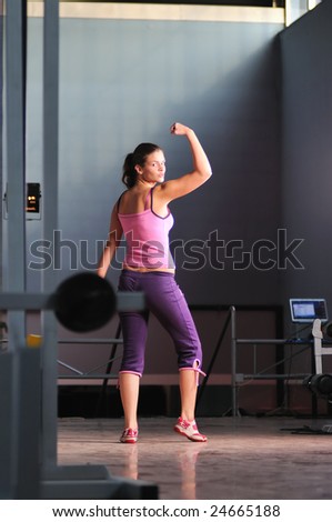 young woman with strong arms rising hands in air and representing their streinght and vitality