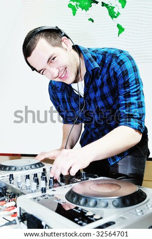 young dj man with headphones and compact disc dj equipment on party