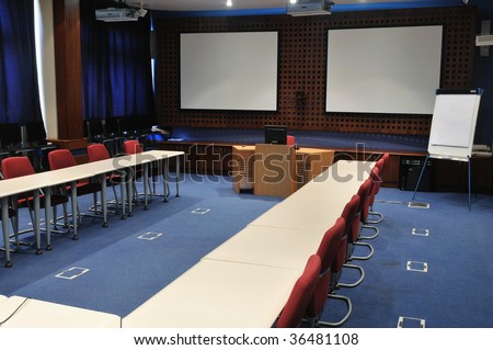 video conference room with chairs and big board  projector canvas and computer