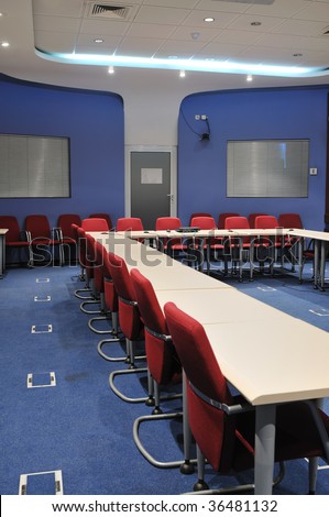 video conference room with chairs and big board  projector canvas and computer