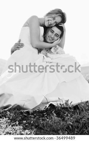 happy bride and groom walking and run on beautiful meadow outdoor at sunset