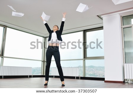 young business woman throw papers and documents from joy in air representing concept of freedom joy and stress control