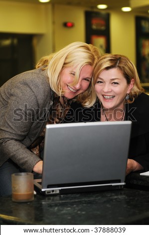 two happy mature senior business  woman work on laptop computer