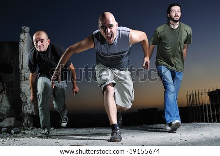 three young man in start position ready to race and run