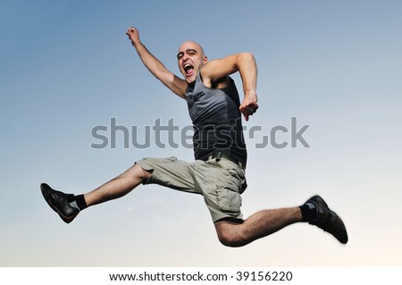 young man jumping in air at sunset outdoor