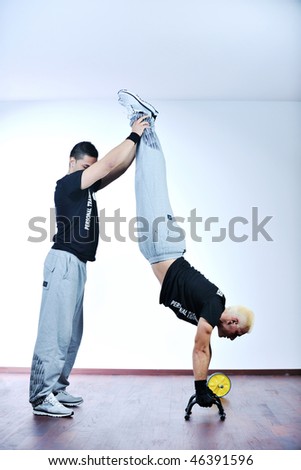man fitness personal trainer in sport club