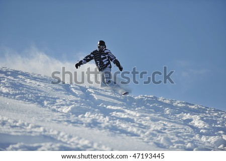 freestyle snowboarder jump and ride free style  at sunny winter day on mountain