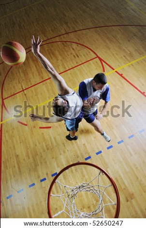competition concept with people who playing and exercise  basketball sport  in school gym