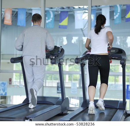 healthy people running on thread mill at sport club representing sport recreation exercise and healthy lifestyle concept