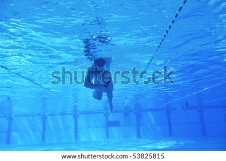 underwater shoot of swimming pool with good looking young swimmer