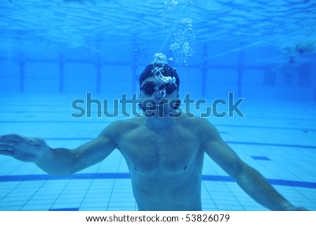 underwater shoot of swimming pool with good looking young swimmer