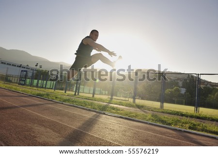 young healthy man run on athletic race sport track and representing concept of sort and speed