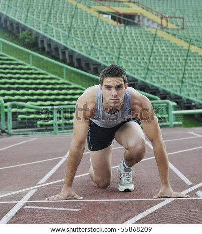 young healthy man run on athletics race sport track and representing concept of sport and speed