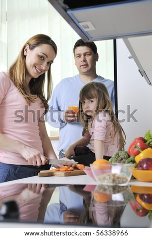 happy young family have lunch time with fresh fruits and vegetable food in bright kitchen