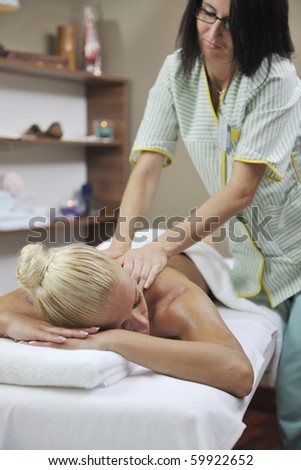 beautiful young woman at spa and wellness back massage treatment